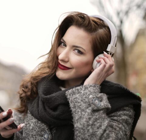 Woman Listening to Podcast with Headphones